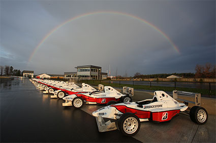 Line up of Van Diemen Formula Cars with rainbow in the background