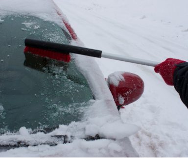 Snow Brush Clearing Snow off Car Windshield