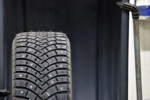 Studded wheel on a balancing machine. Seasonal tire replacement