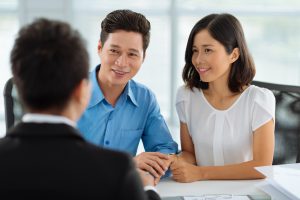 Asian married couple at the meeting with financial advisor