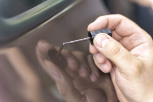 master paints a dent on a car with auto enamel