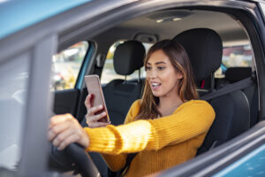 Teenager in Yellow Sweater Texting While Driving