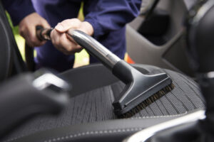 Vacuuming the interior of the vehicle. 