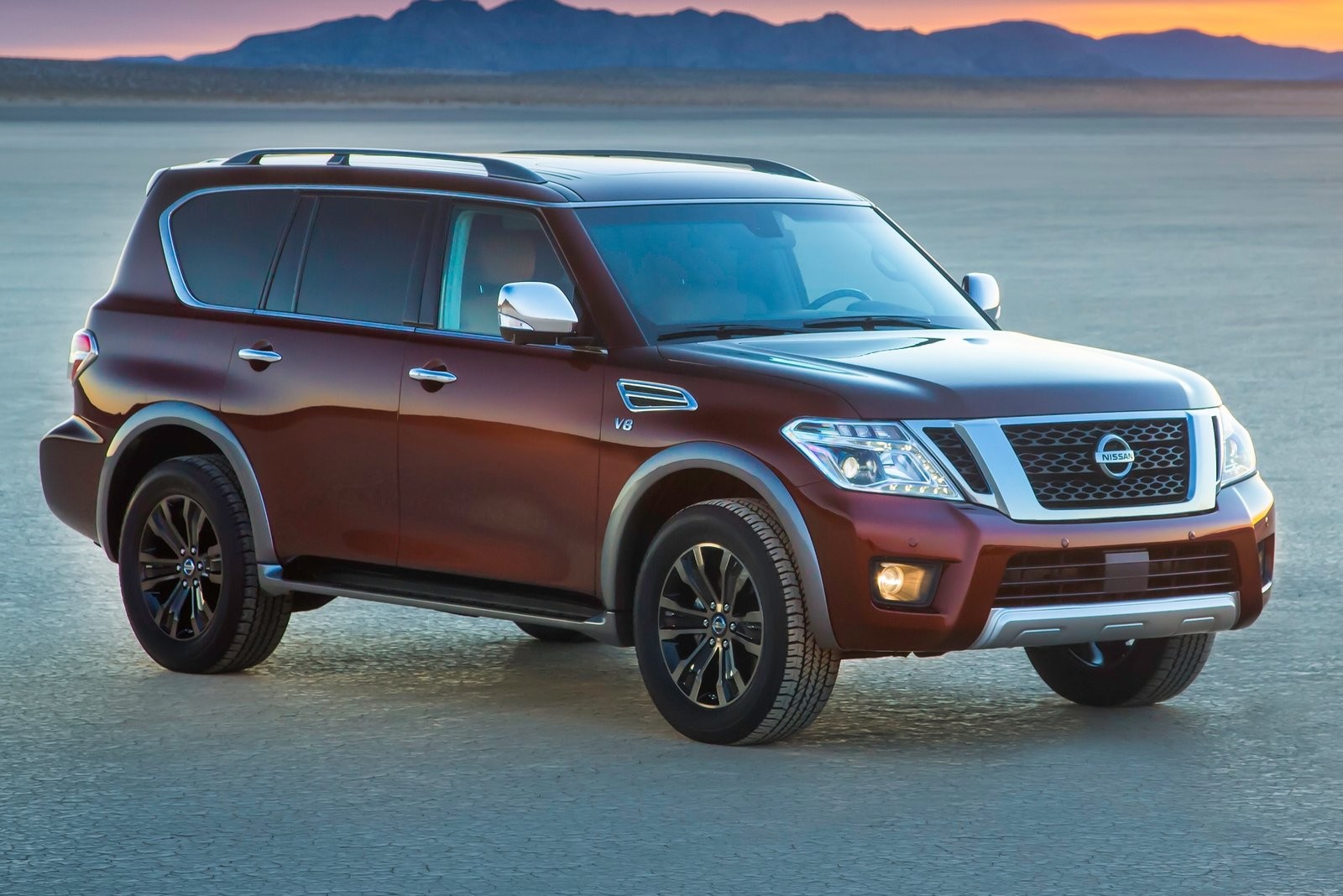 The 2012 Nissan Armada park on a salt flat at sunset.