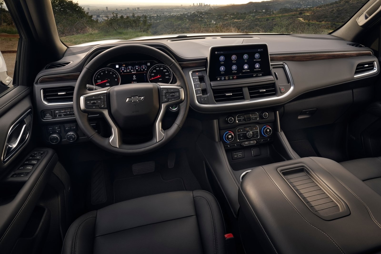 The interior of a 2022 Chevrolet Tahoe with the interior lights and center consol on.