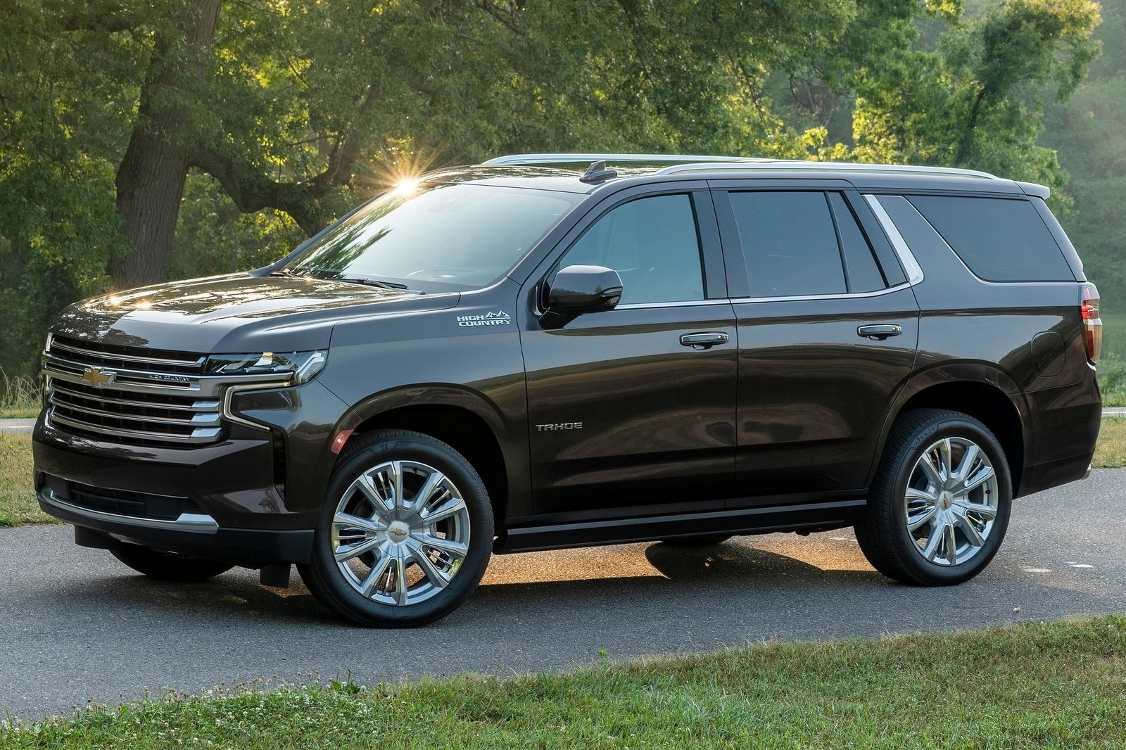 2022 Chevrolet Tahoe High Country parked by a tree.