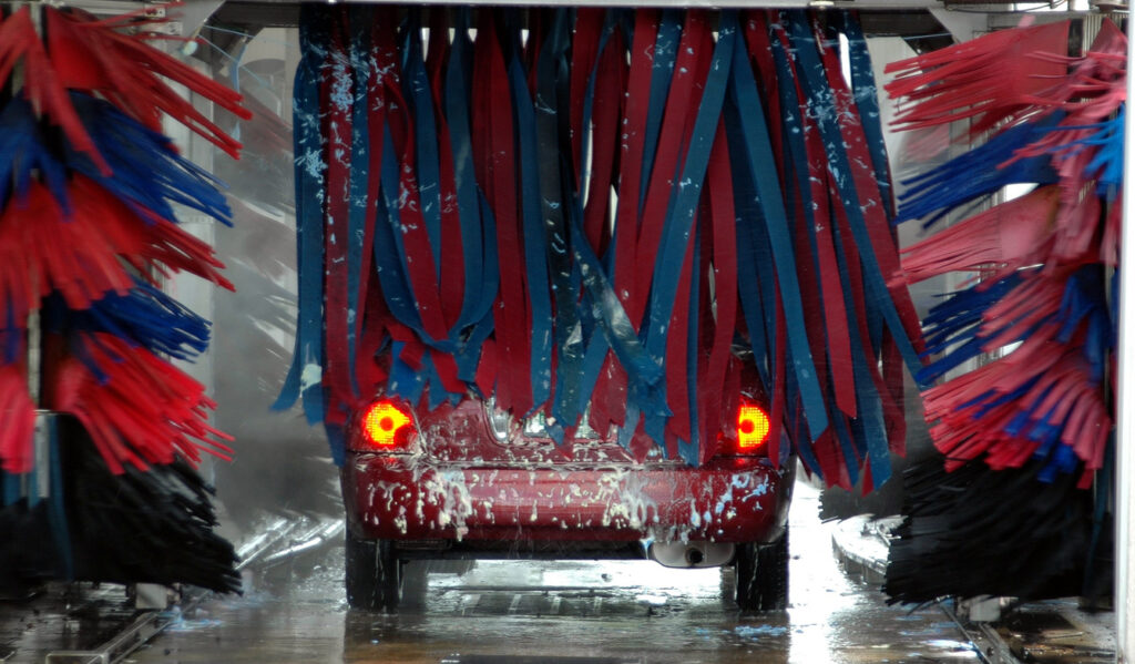 red car going through Car Wash