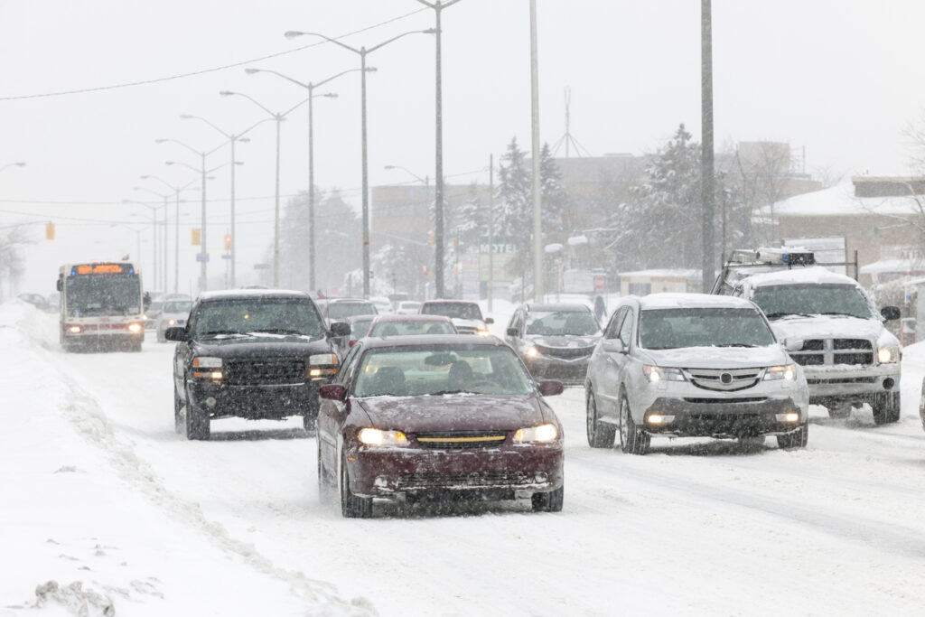 Cars driving on slippery road during heavy snowfall in Toronto